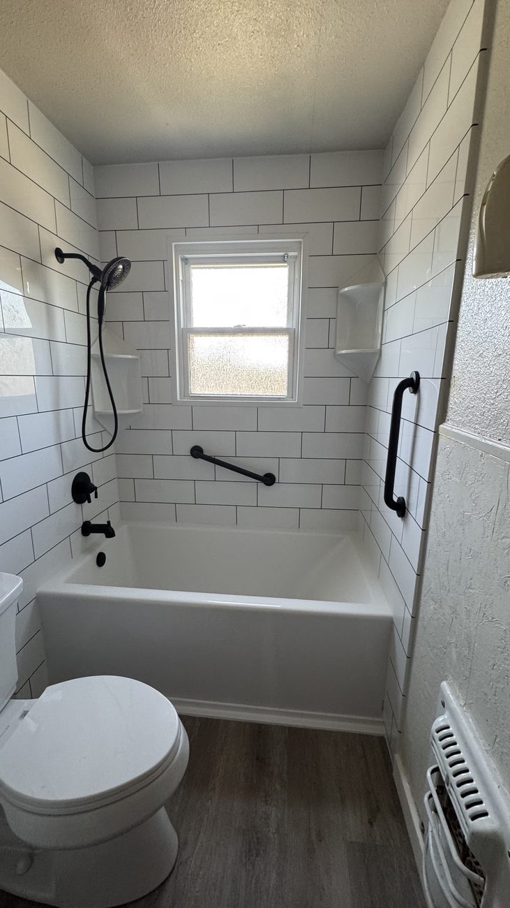 Subway-tile tub and surround with black fixtures