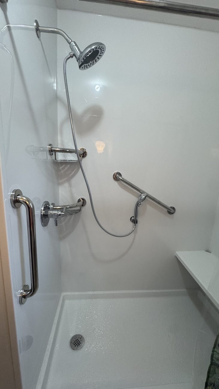 White accessible shower with grab bars