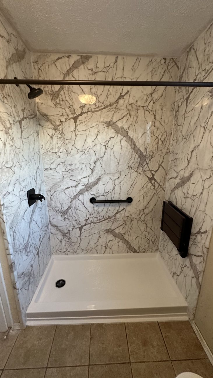 Marble-look shower with bench and matte-black fixtures